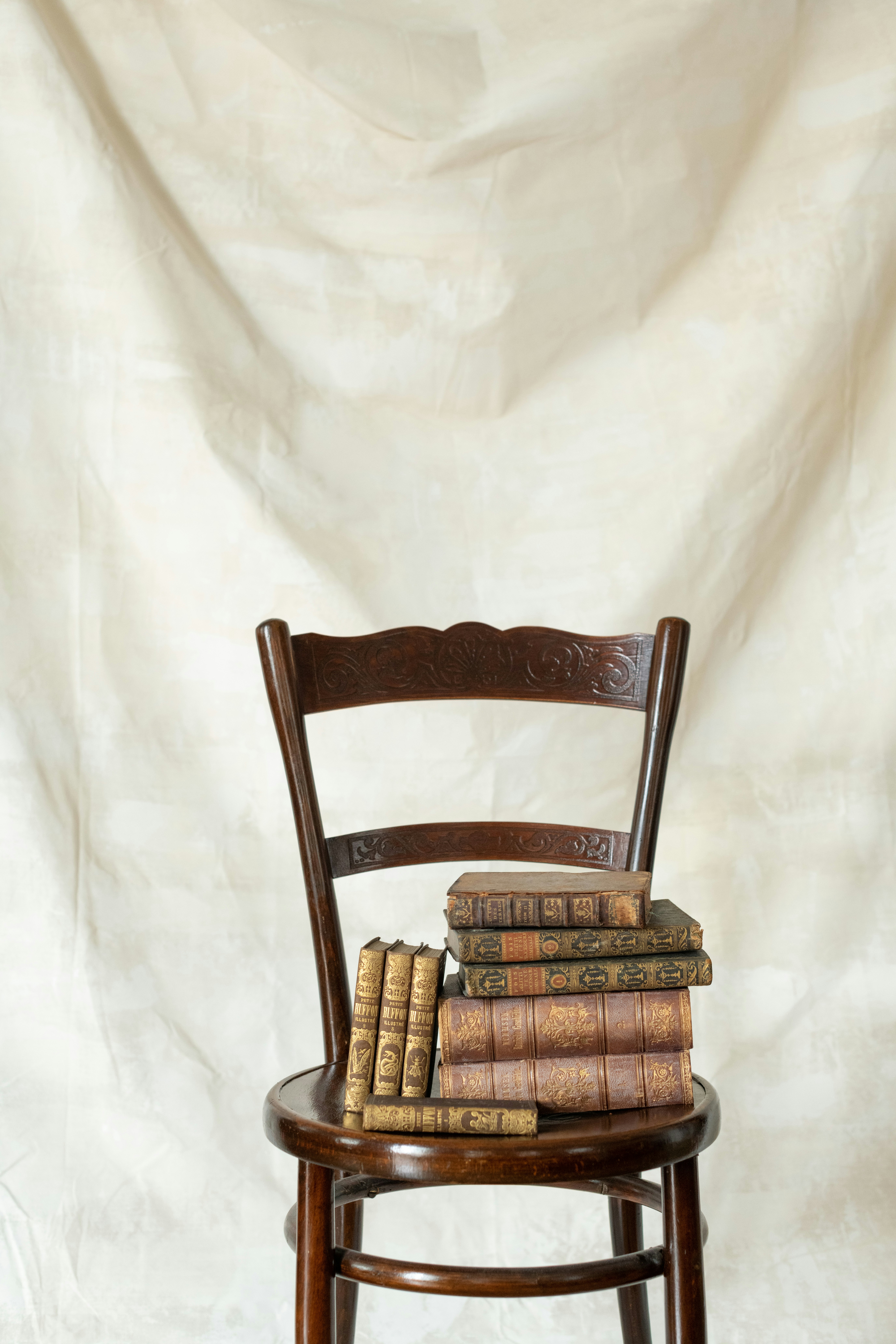 Chair and books against white backdrop